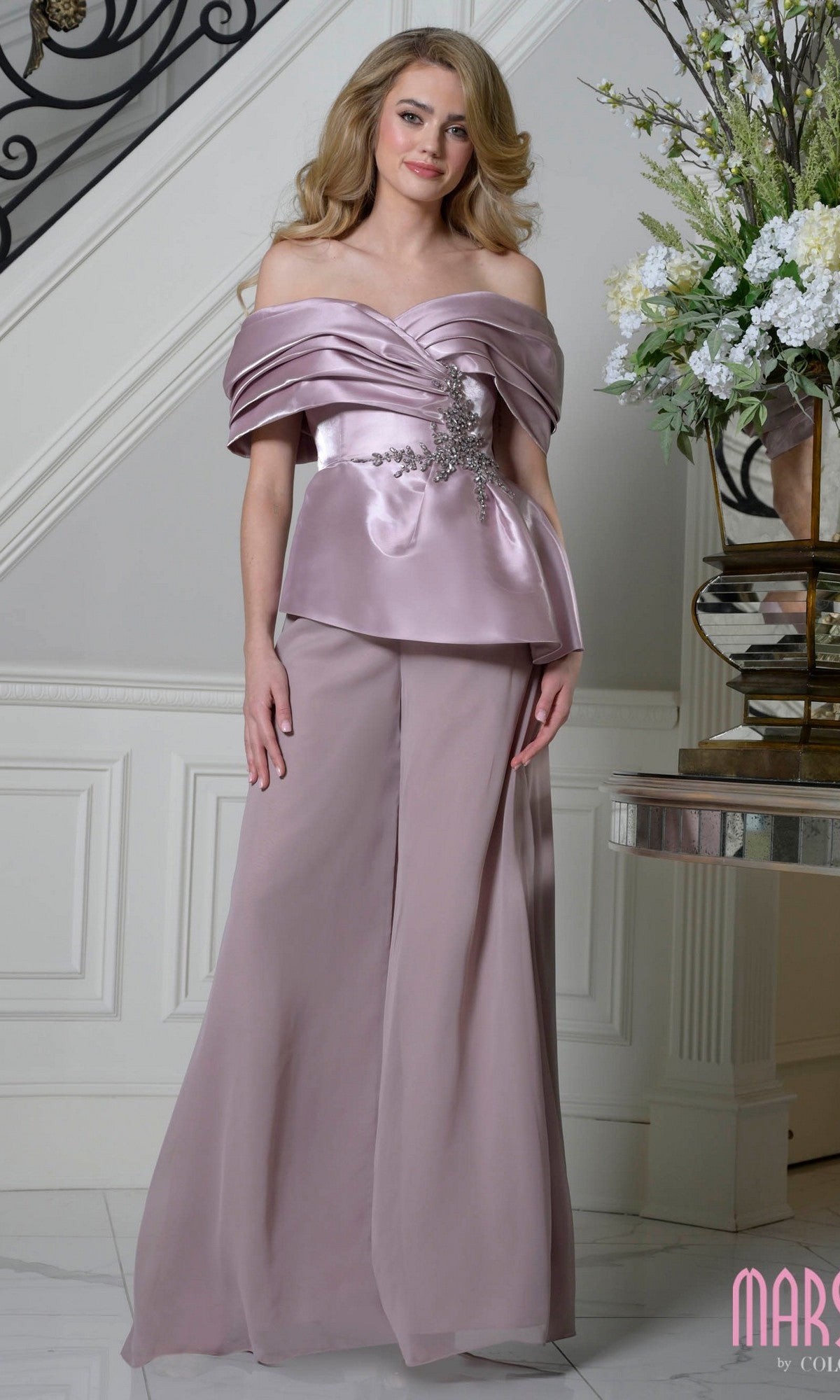 A woman stands indoors wearing the Marsoni MV1410 long formal dress in mauve.